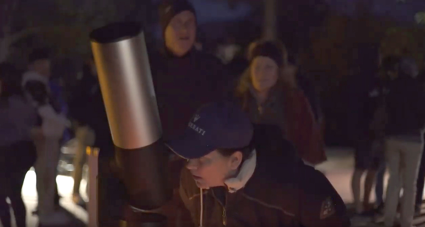 Woman looking through Unistellar's eVscope