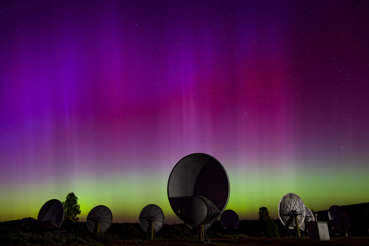 ATA under aurora-like lights in in the sky - purple, pink, and green.