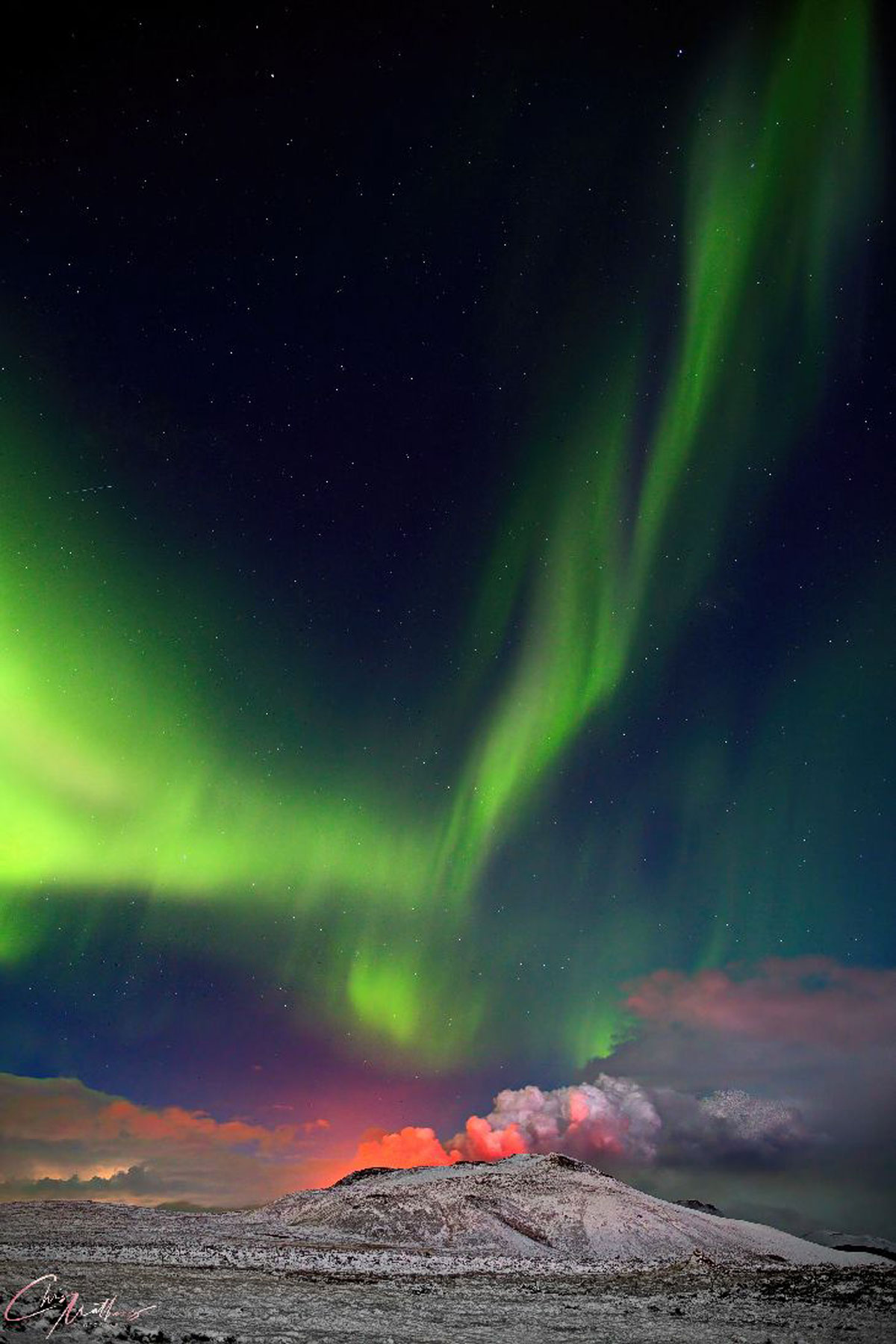 Aurora over erupting volcano