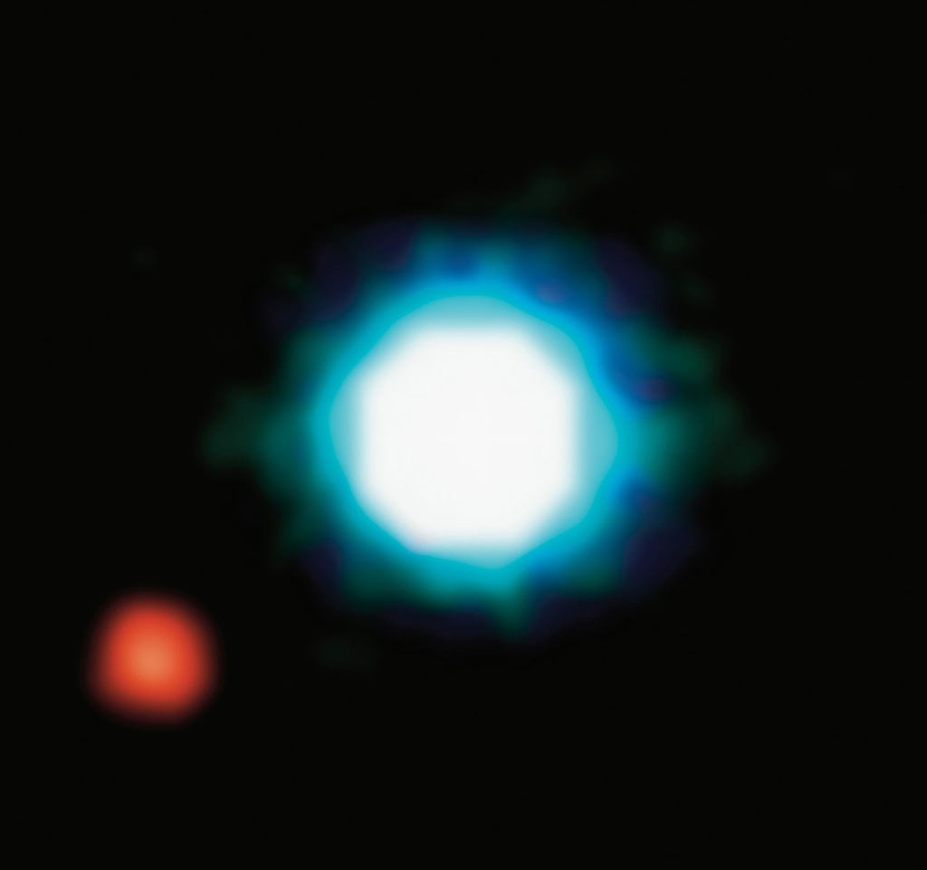 blurred image of a big white and blue light with a smaller red light next to it