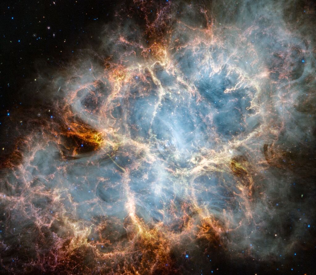 bright orange, yellow, blue, and green tones of the crab nebula