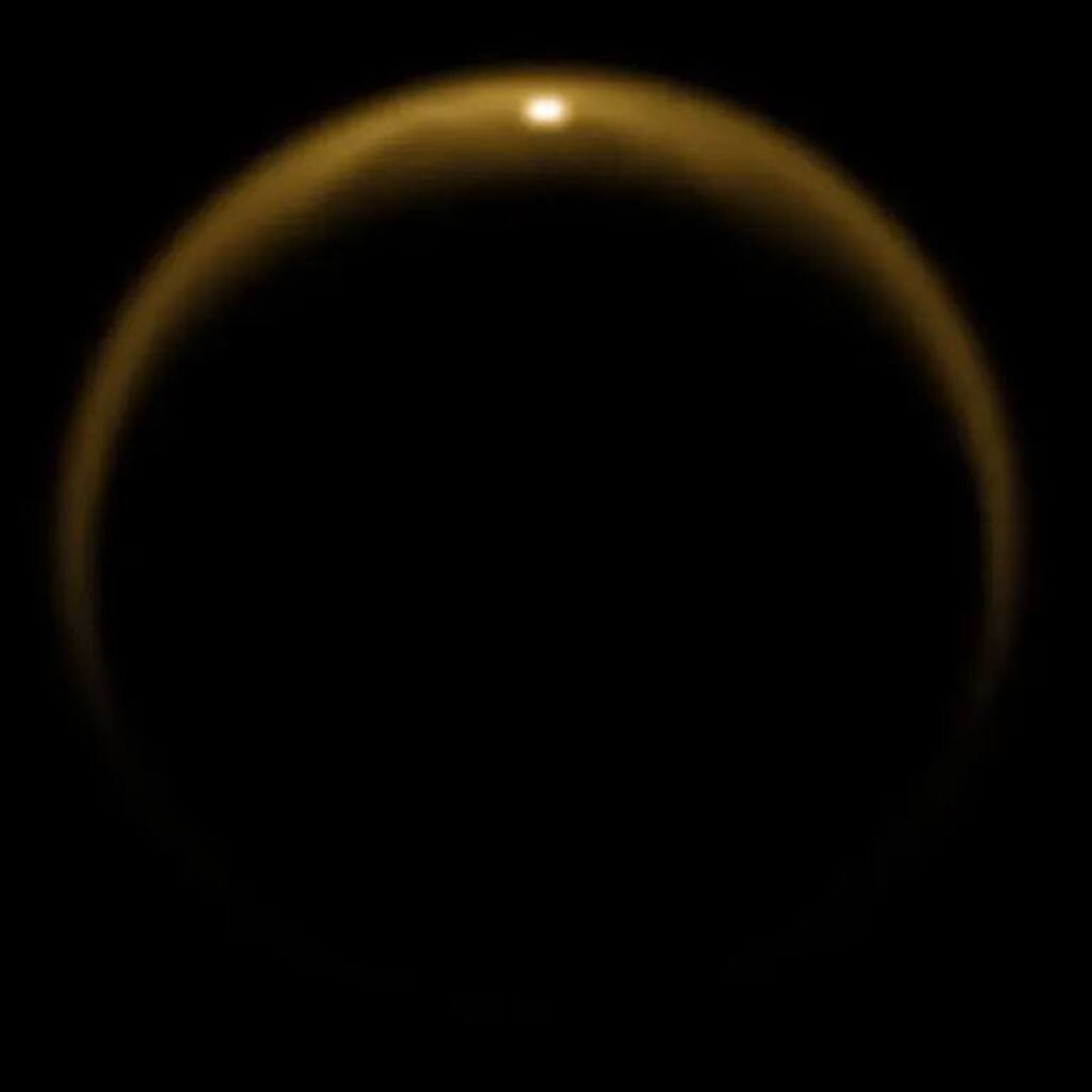 dark and blurry reflection of the sun in water