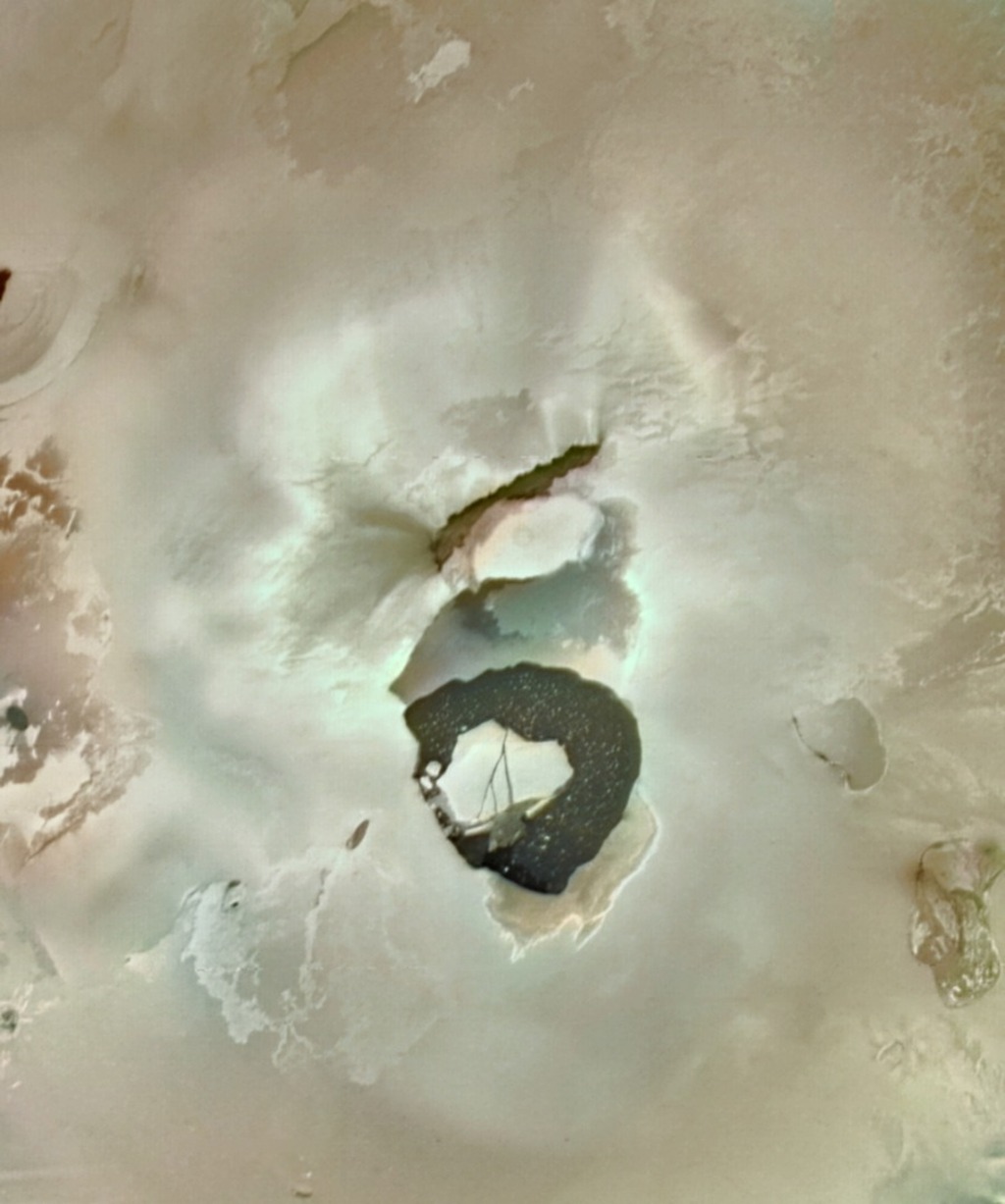 Depression on the beige surface of Io
