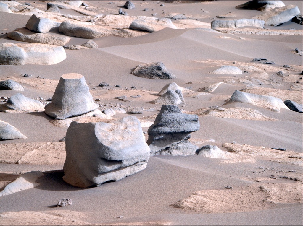 smooth rocks in different shapes on the surface of Mars