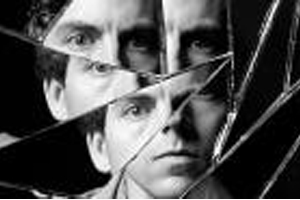 shattered mirror and man's face