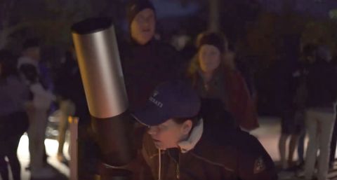 Woman looking through Unistellar's eVscope