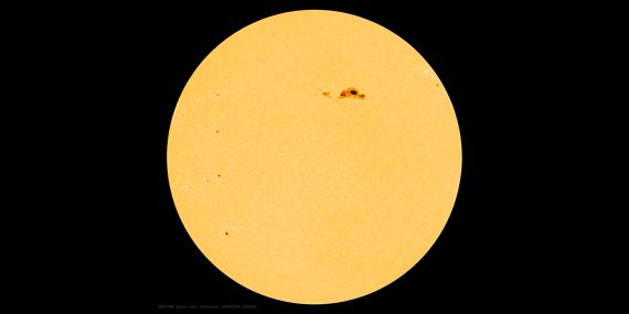 the Sun with a dark spot on upper right