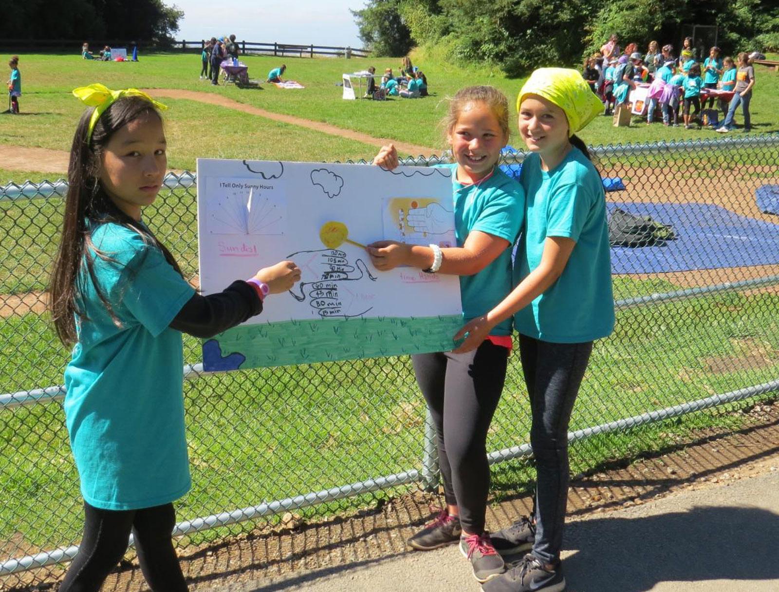 Girl Scouts Holding Poster