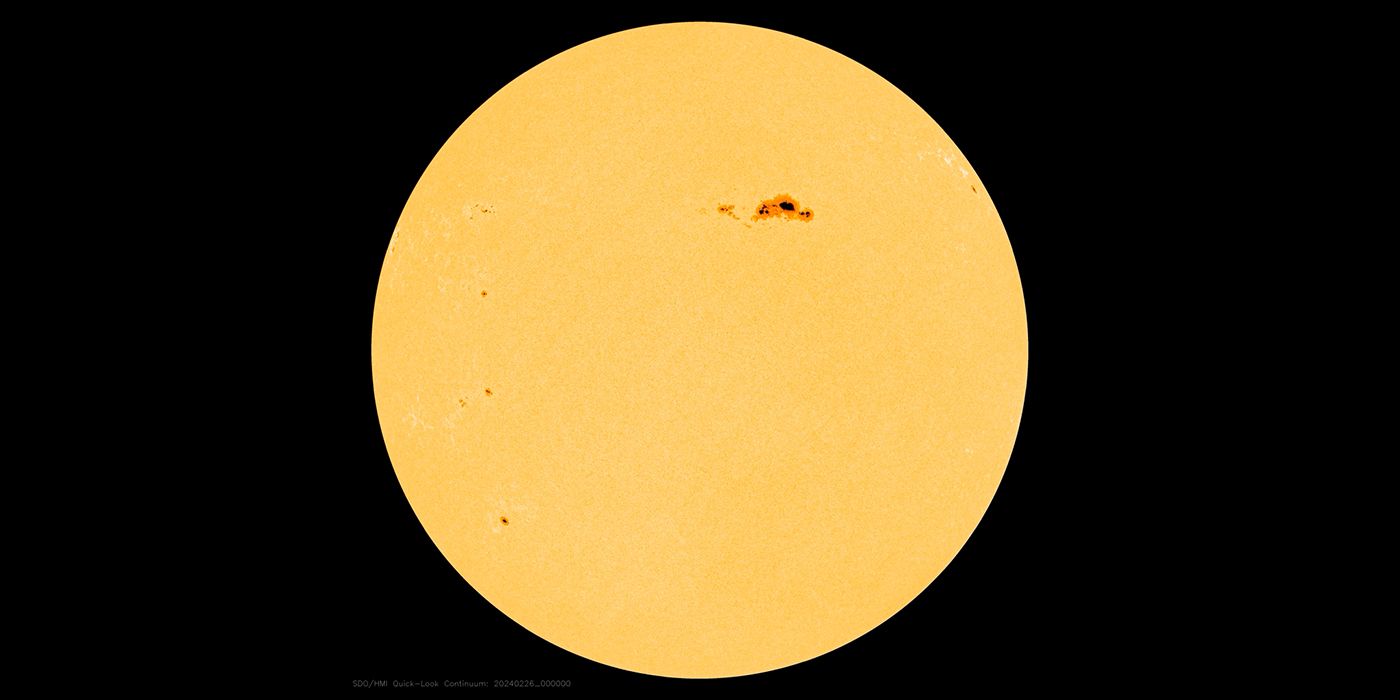 the Sun with a dark spot on upper right