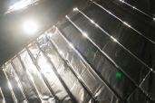 TX-2: MOONSHADOW (2022) handmade mylar solar sail, custom machined aluminum, measuring tapes, Kapton tape, custom mylar tape, custom electronics, sculpted rock made from simulated Martian regolith, various lichen species, Homestead meteorite fragment; approximately 4m x 4m; detail